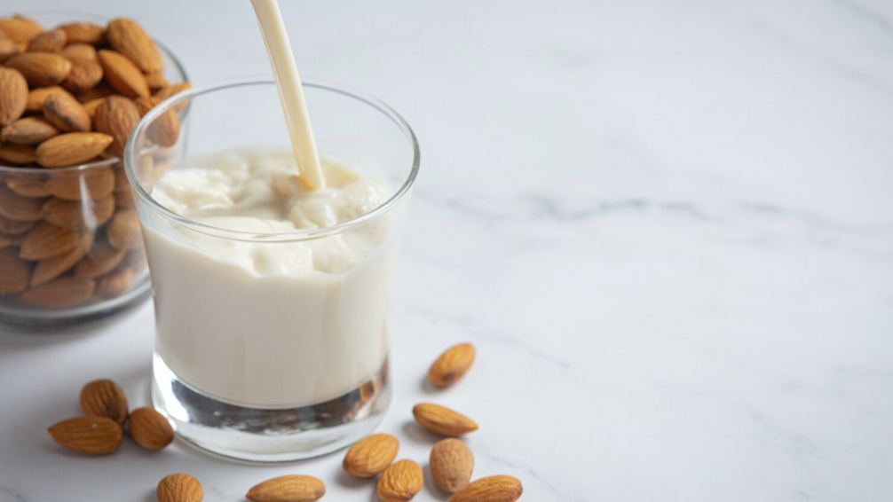 Almond milk being poured into a glass