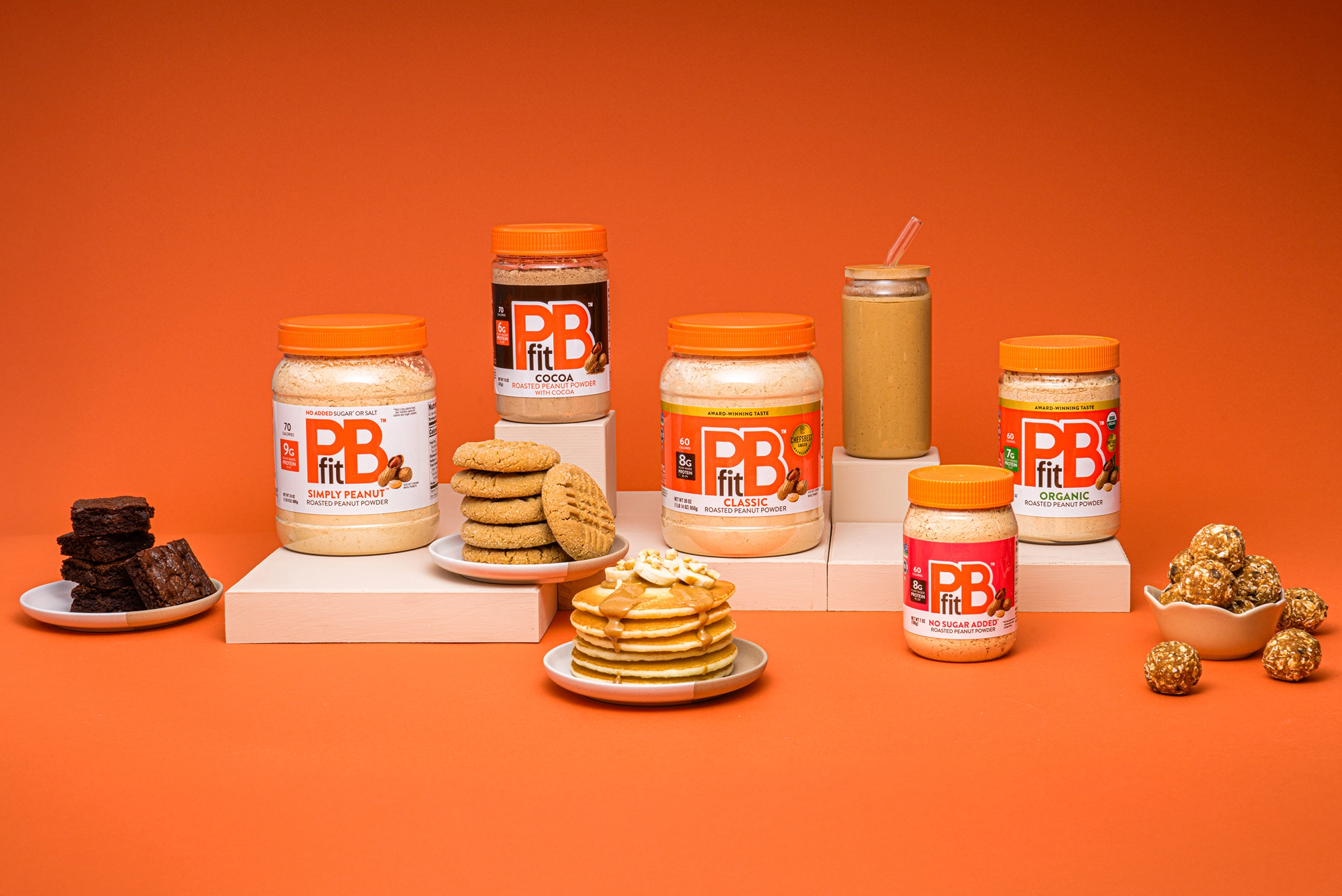 PBFit product lineup on orange background with example recipes